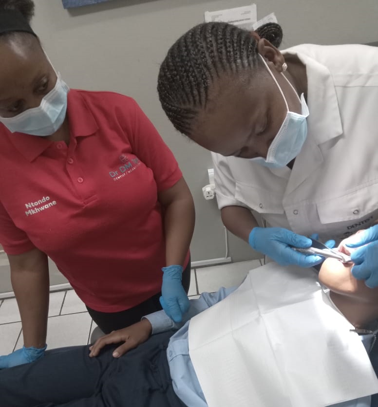 Dentist filling a patients tooth